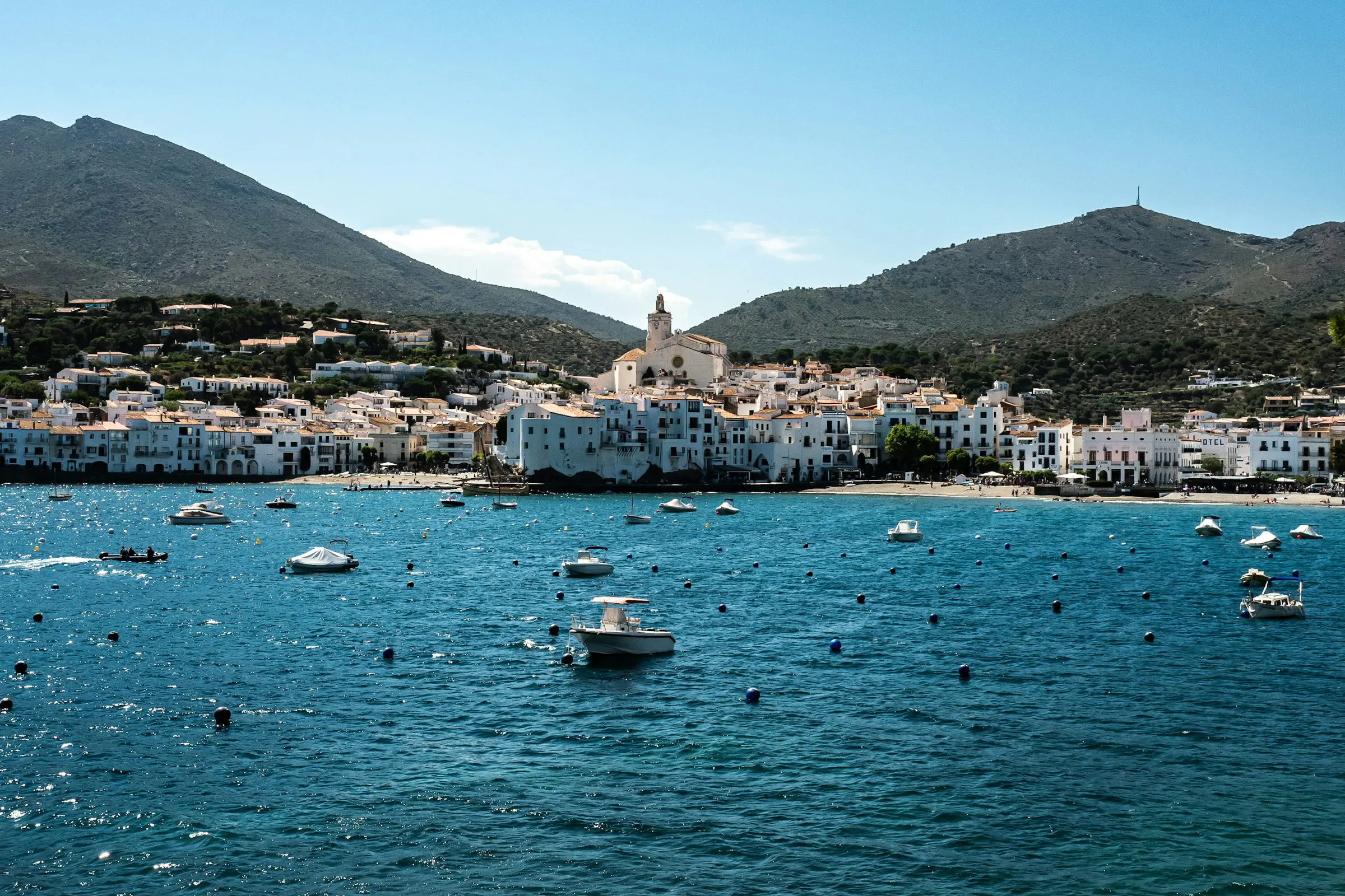 Sea towards a harbor with boats and city in Spain