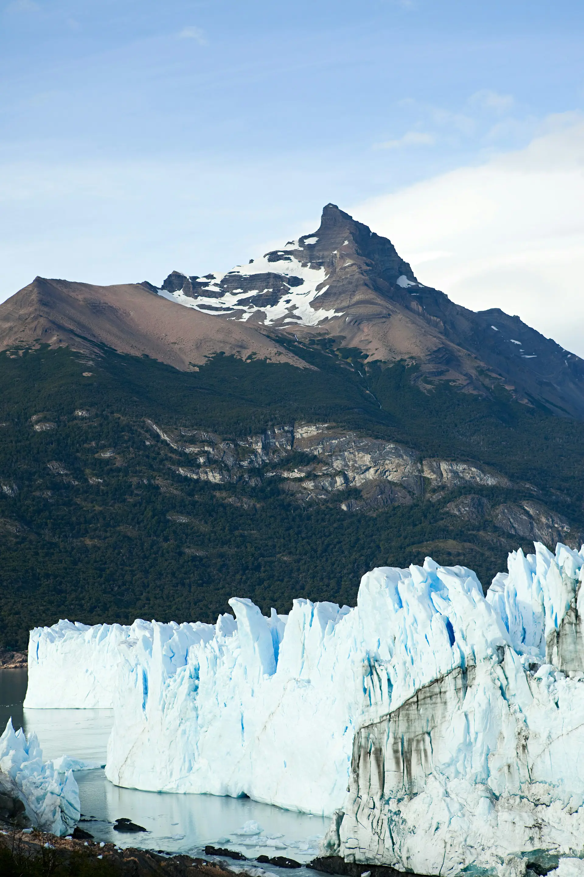 Snow-capped mountain peak above a vast glacier in Patagonia, Argentina.