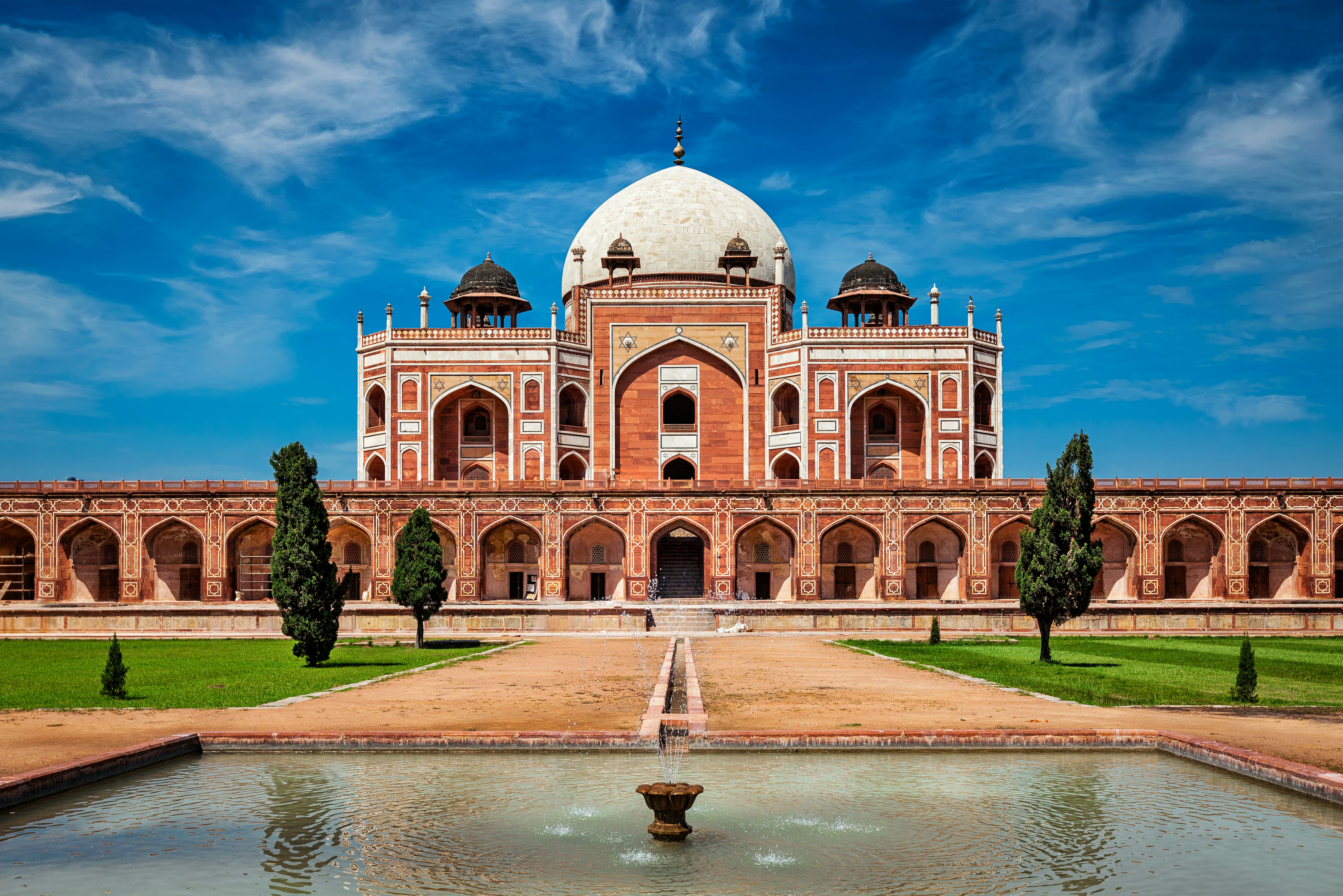 Trip to Delhi - Humayun's Mausoleum in Delhi, India, a magnificent red sandstone and marble structure under a clear blue sky.