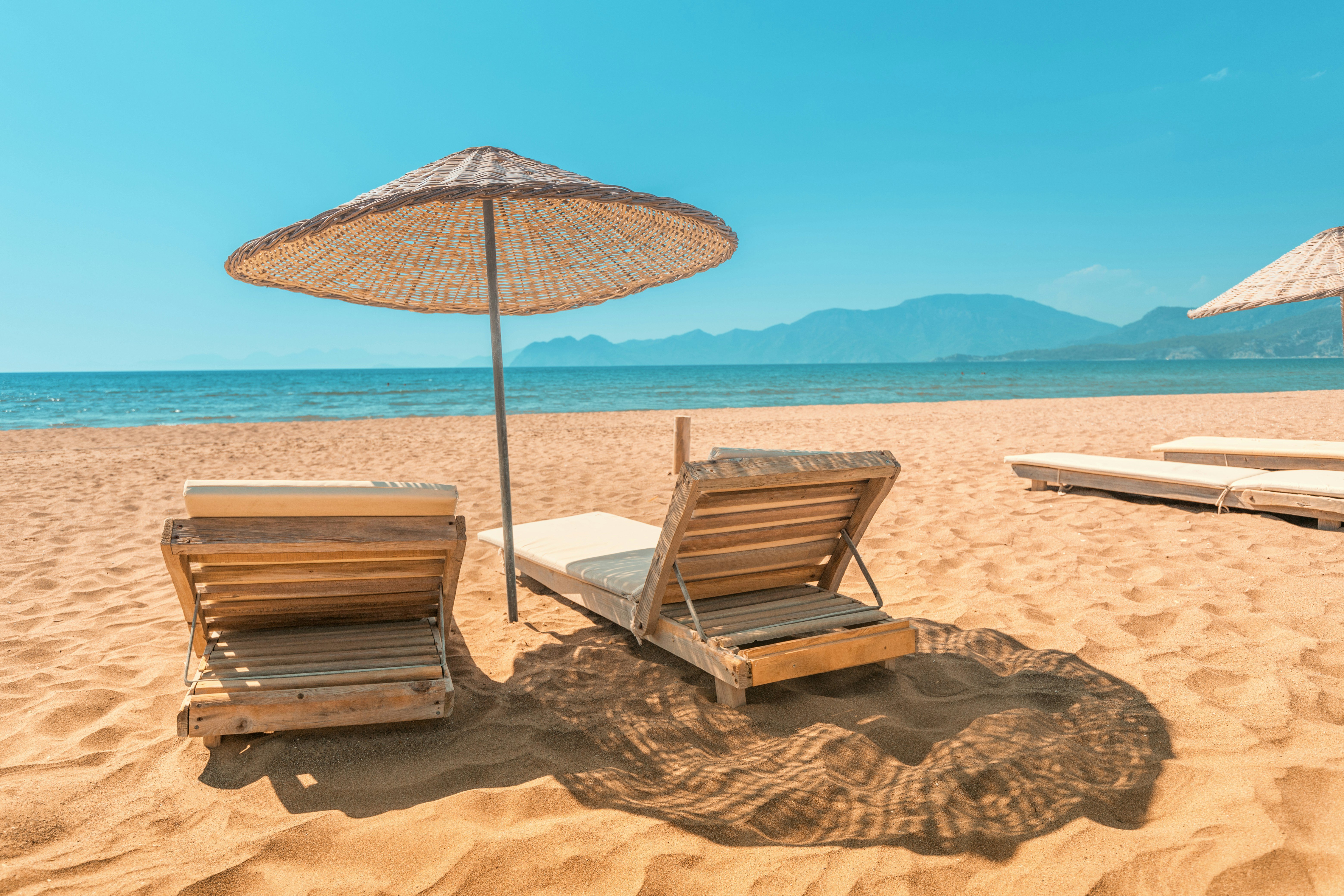 Sun loungers on a beach with the sea in the background in the Caribbean