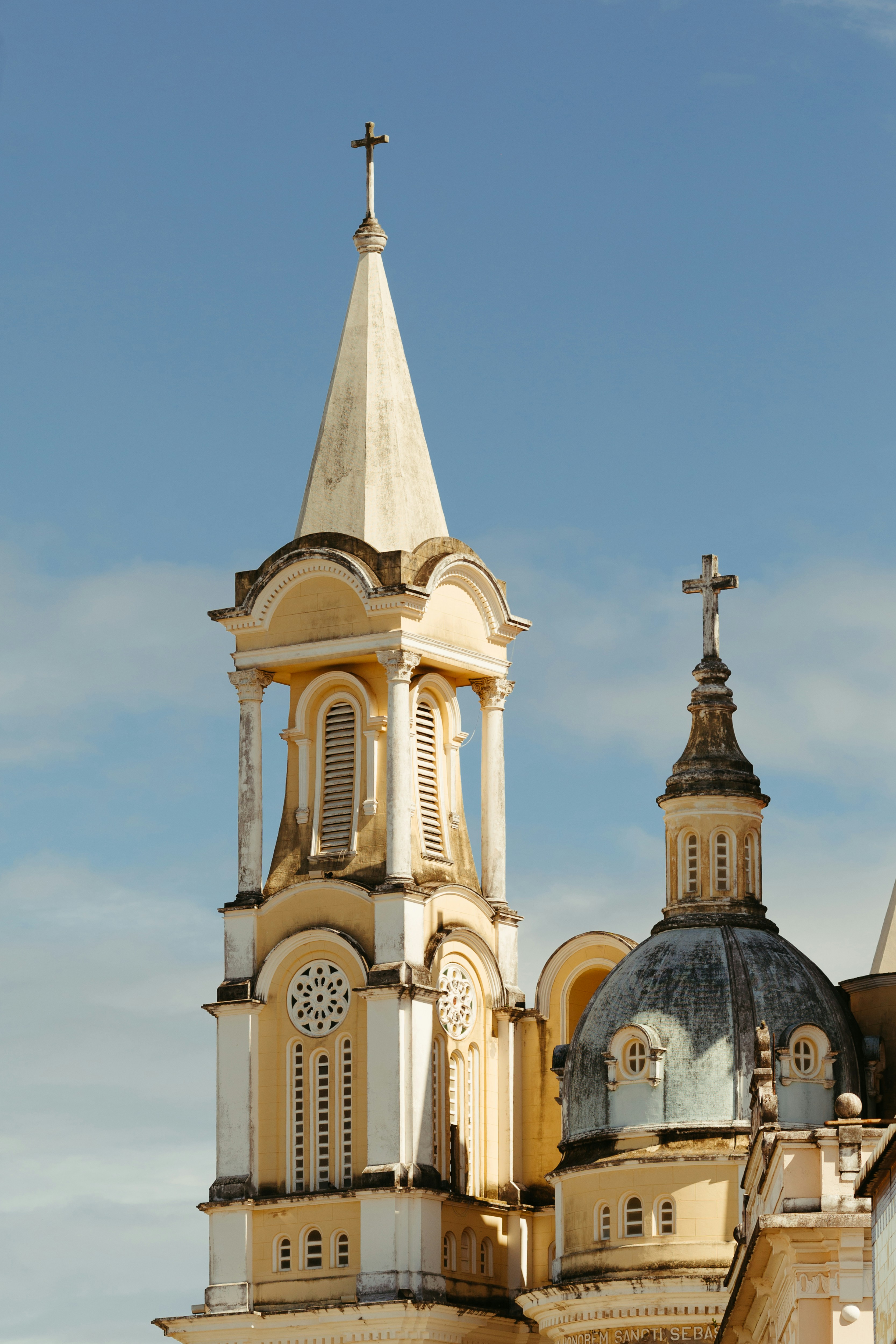 Renaissance-style church steeple and dome against a clear blue sky