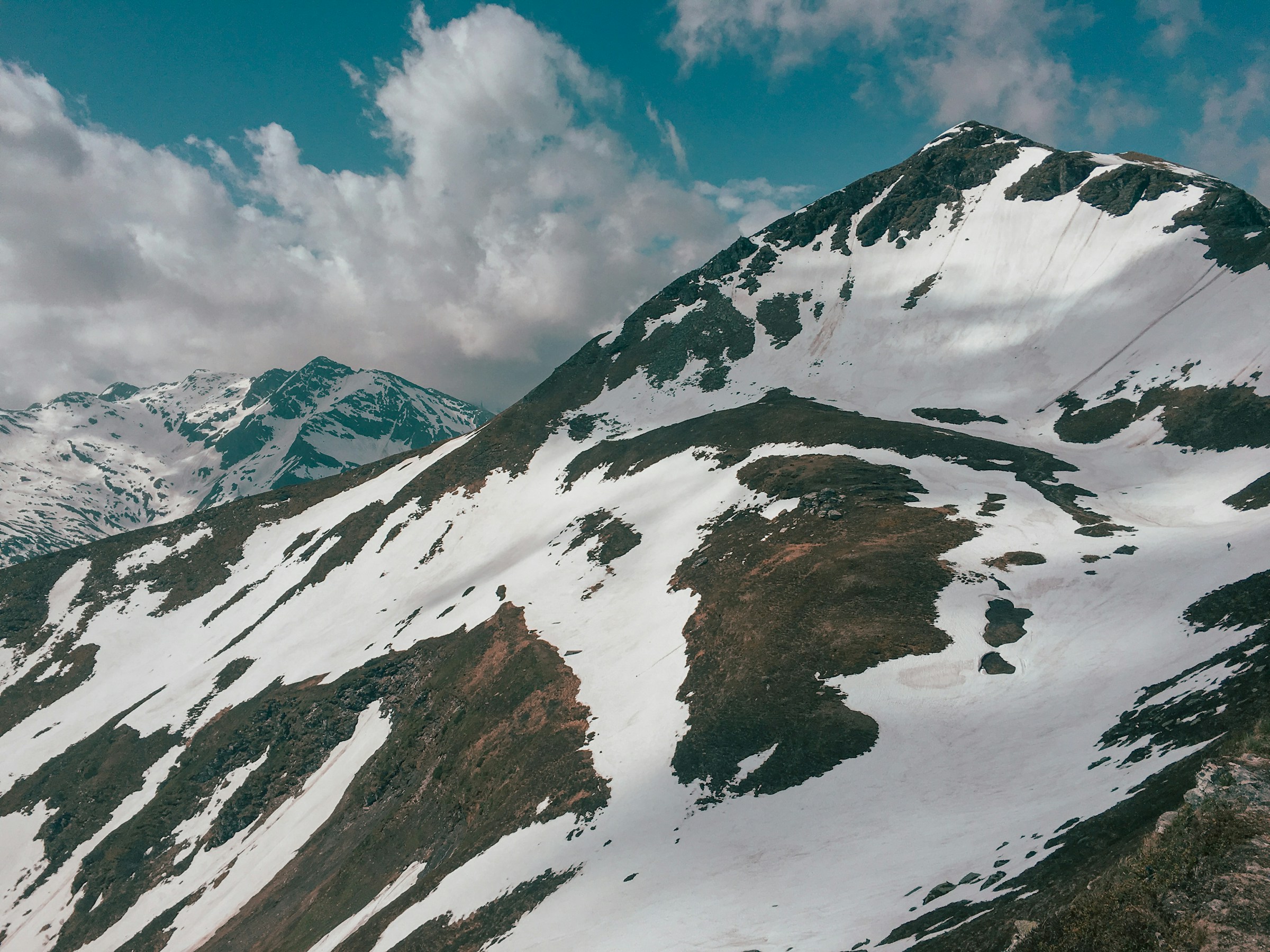 Snow-capped mountain peaks against blue skies in Bad Gastein, Austria's part of the Alps.