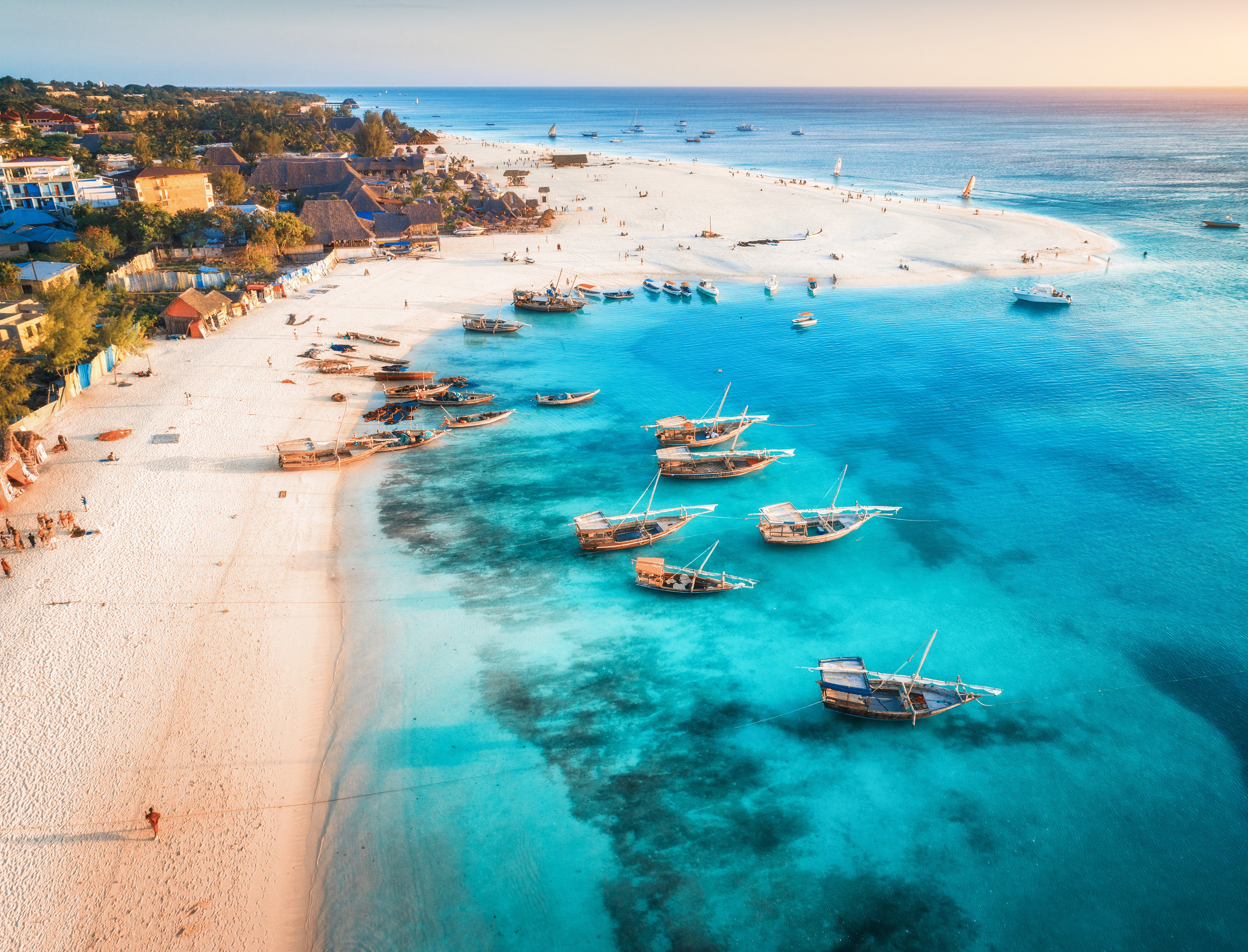 Beach and crystal clear blue sea coming in at Zanzibar coast