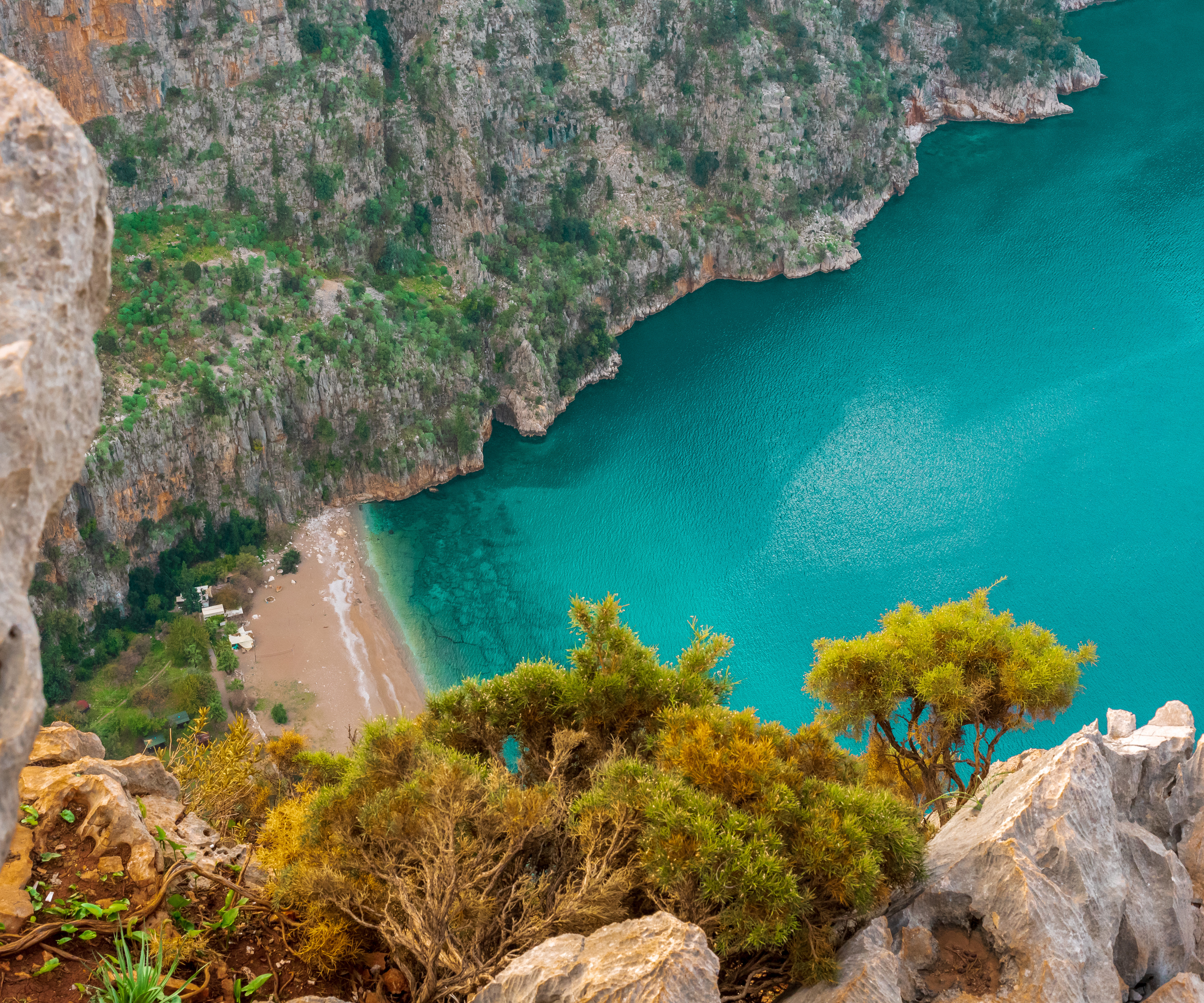 Scenic view of Butterfly Valley in Turkey with turquoise waters, sandy beach, and lush cliffs