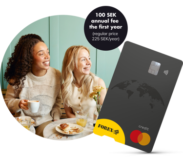 Two women enjoying breakfast and coffee at a cafe, smiling and talking. A credit card with a world map design and promotional message about a 100 SEK annual fee for the first year is prominently displayed in the corner.