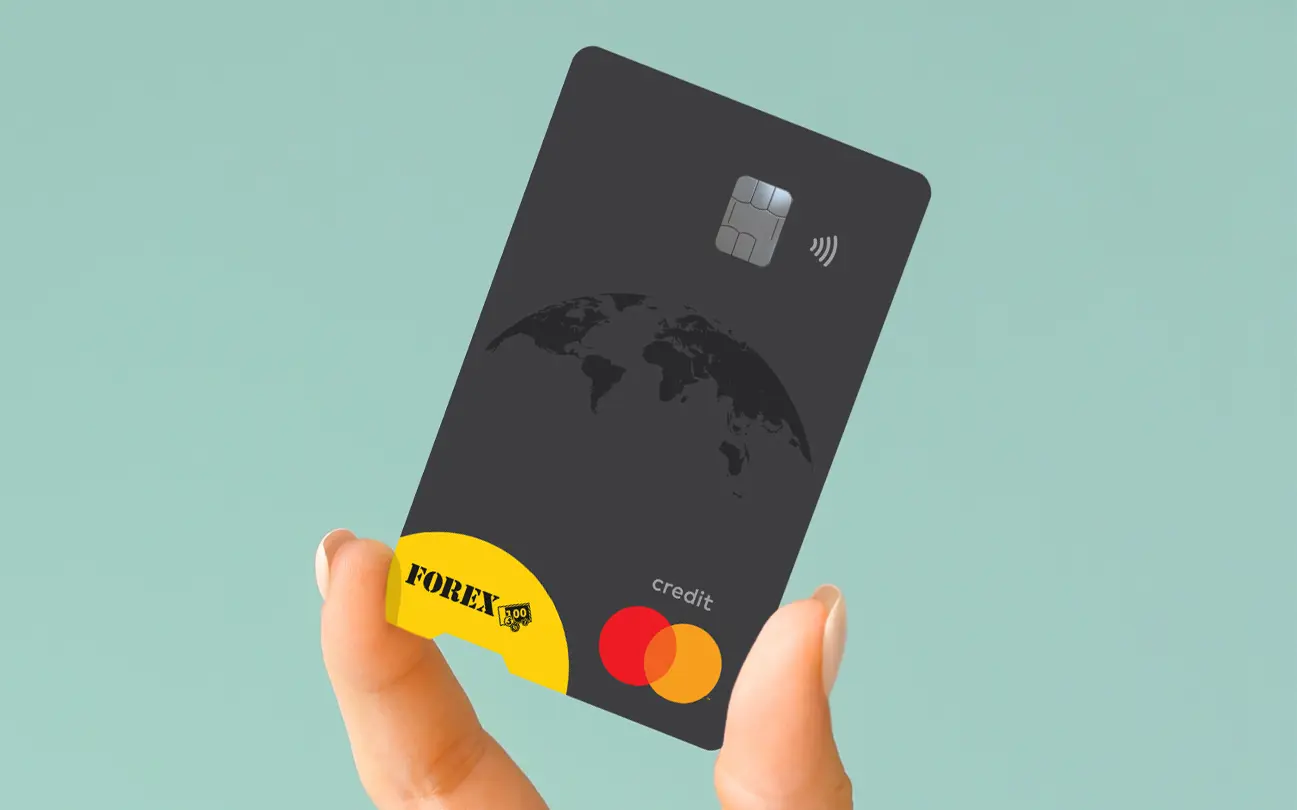 Hand som håller ett svart FOREX Kreditkort med Mastercard-logotyp mot en turkos bakgrund.